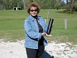 Brenda Archambo holding a telemetry receiver deployed in Black Lake.